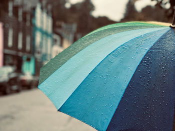 Raindrops on a multi coloured umbrella