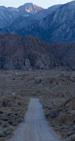 Dirt road leading into the alabama hills and sierra nevadas at dusk