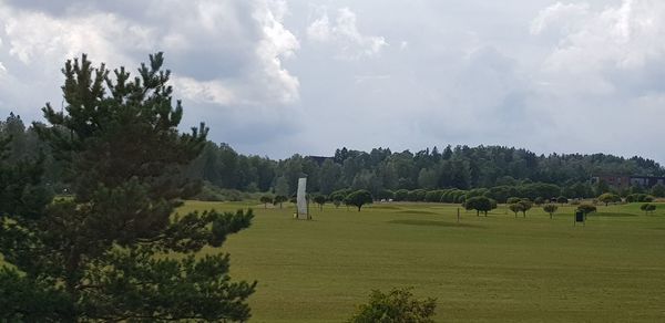 Panoramic shot of trees on field against sky