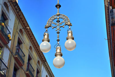 Low angle view of street light against buildings