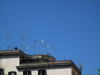 High section of building against clear blue sky