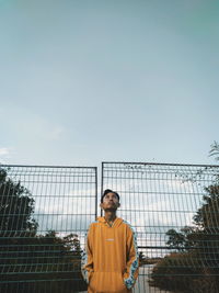 Portrait of man standing against sky