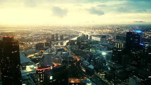 Cityscape against cloudy sky