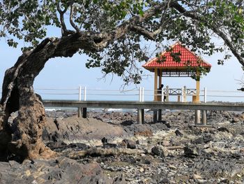 Gazebo at beach against sky