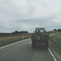 Empty road along countryside landscape