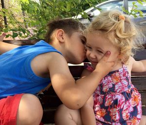Loving brother kissing sister