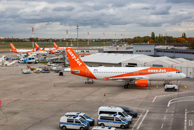 Airplane on airport runway against sky