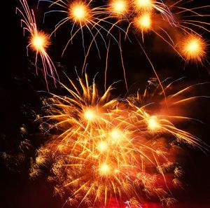 Low angle view of firework display at night