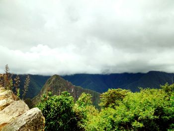 Panoramic shot of countryside landscape against cloudy sky