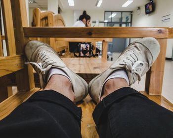 Low section of man sitting on bench