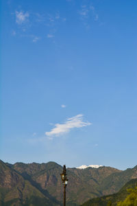 Scenic view of mountains against blue sky