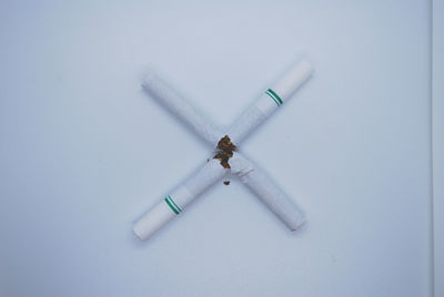 High angle view of cigarette against white background