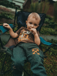 Full length of cute boy holding baby