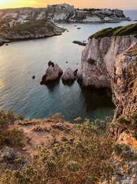 High angle view of rocks on sea shore