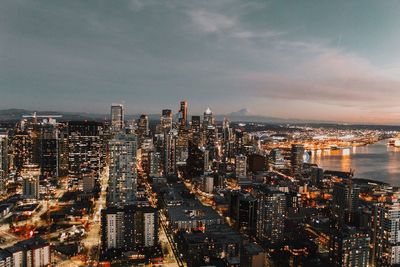 High angle view of illuminated buildings against sky in city