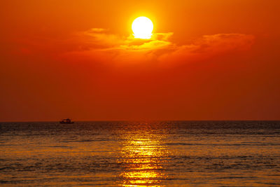 Scenic view of sea against orange sky