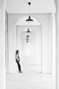 Full length of woman standing on wall