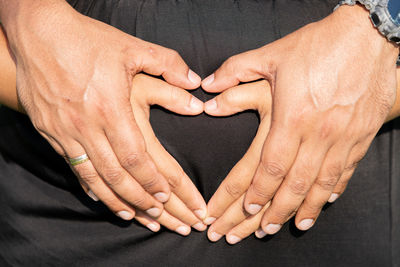 Close-up of hands on stomach