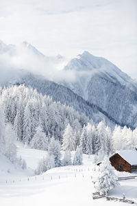 Winter scenery. snow covered traditional wooden hut in the austrian alps