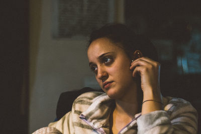 Portrait of young woman sitting at home