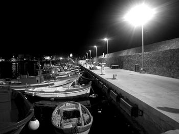 Illuminated boats moored at night
