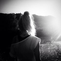 Rear view of woman standing against sky