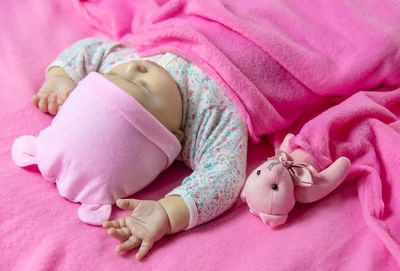 High angle view of baby girl sleeping on bed at home