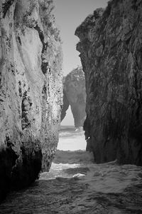 Rock formations by sea against sky