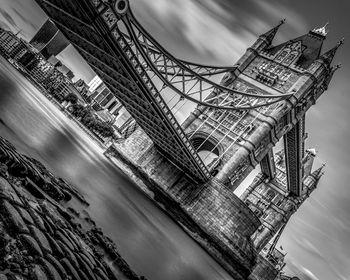 Low angle view of bridge against cloudy sky