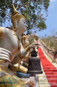 Low angle view of statue against trees