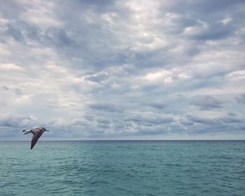 Man in sea against sky