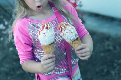 Midsection of girl holding ice cream