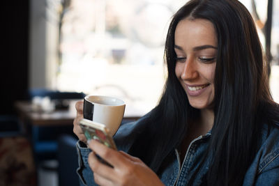 Close-up of woman holding coffee cup