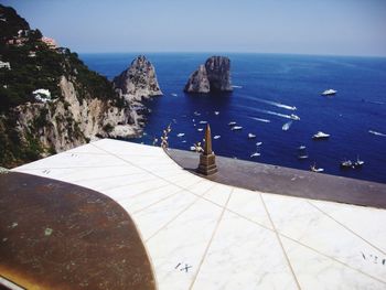 High angle view of sundial against sea