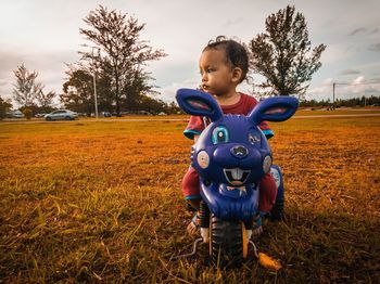 Boy looking away on field