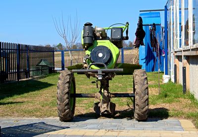 Tractor on field against clear sky