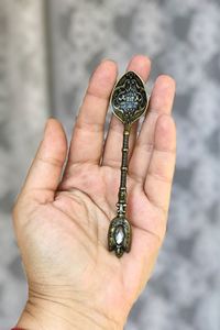 Close-up of hand holding spoon