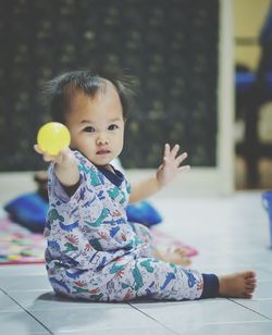 Portrait of cute girl sitting on floor