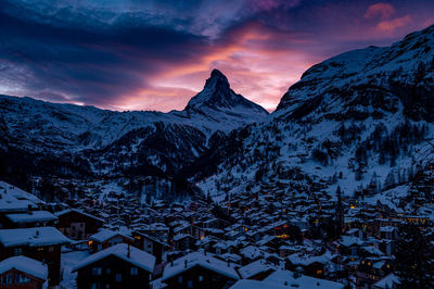 Scenic view of snowcapped mountains against sky during sunset