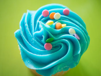 Close-up of multi colored candies against blue background