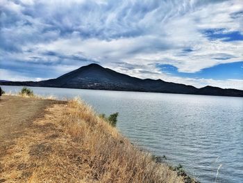 Scenic view of lake and mountains against sky