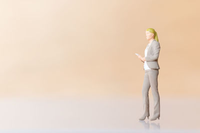 Side view of a woman holding white background