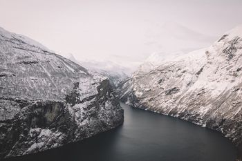 Scenic view of river amidst mountains against sky