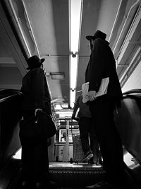 Rear view of people standing in bus