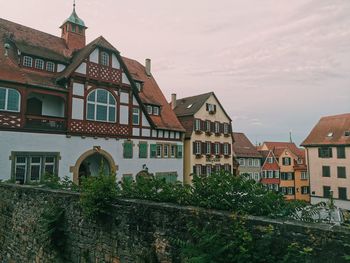 Low angle view of buildings in town against sky