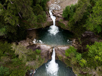 Cascading waterfall from above in the forest