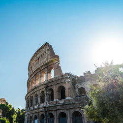 Low angle view of coliseum against clear sky