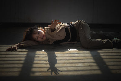 Full length of young woman lying on bed