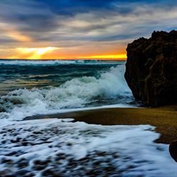 Scenic view of sea against cloudy sky