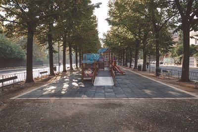 Trees in park against sky in city